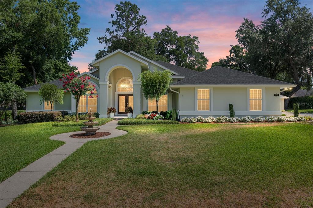 a front view of a house with a garden and porch