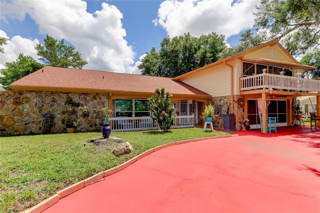 a view of a house with a yard porch and sitting area