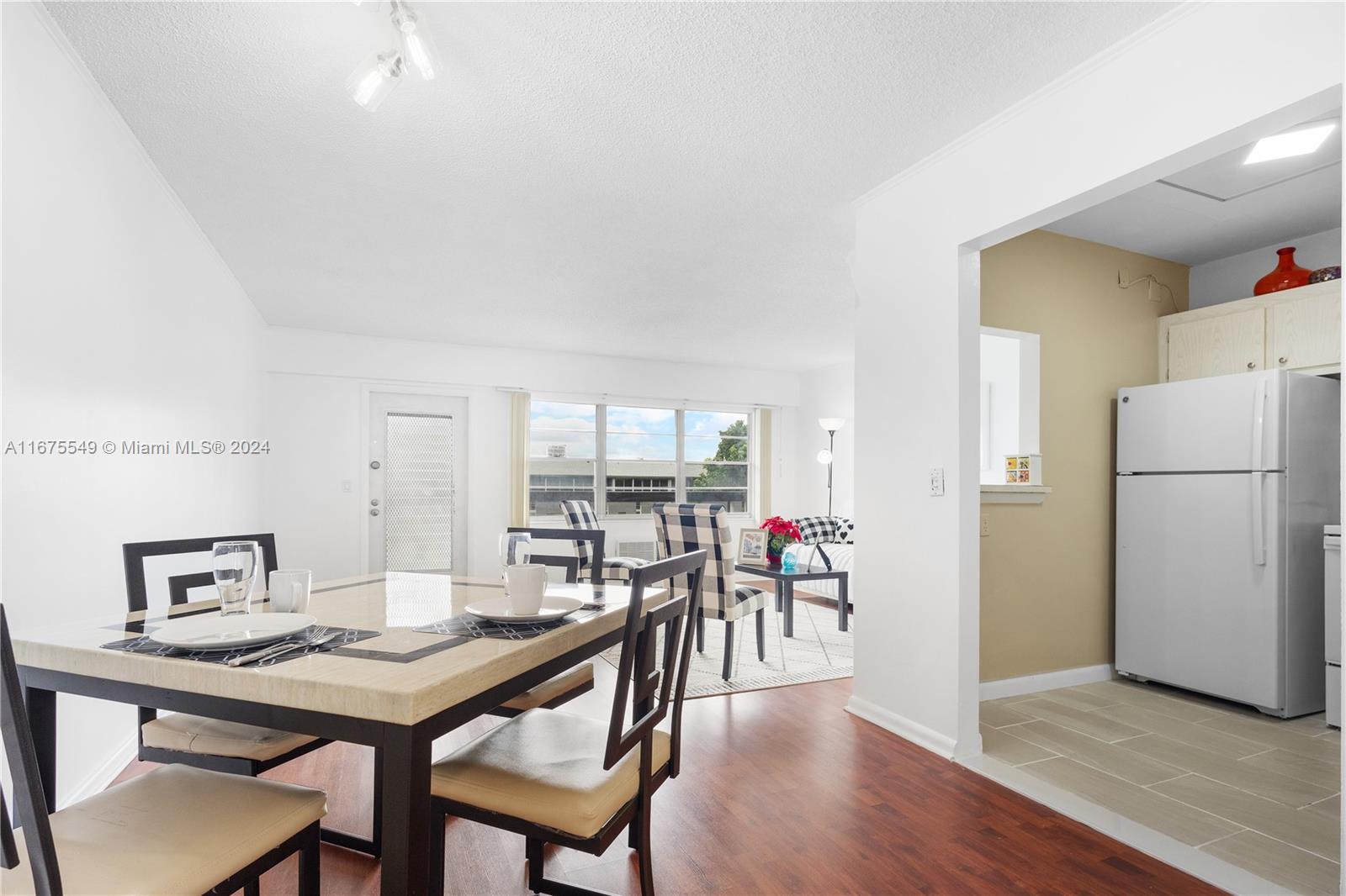 a view of a dining room with furniture and a wooden floor