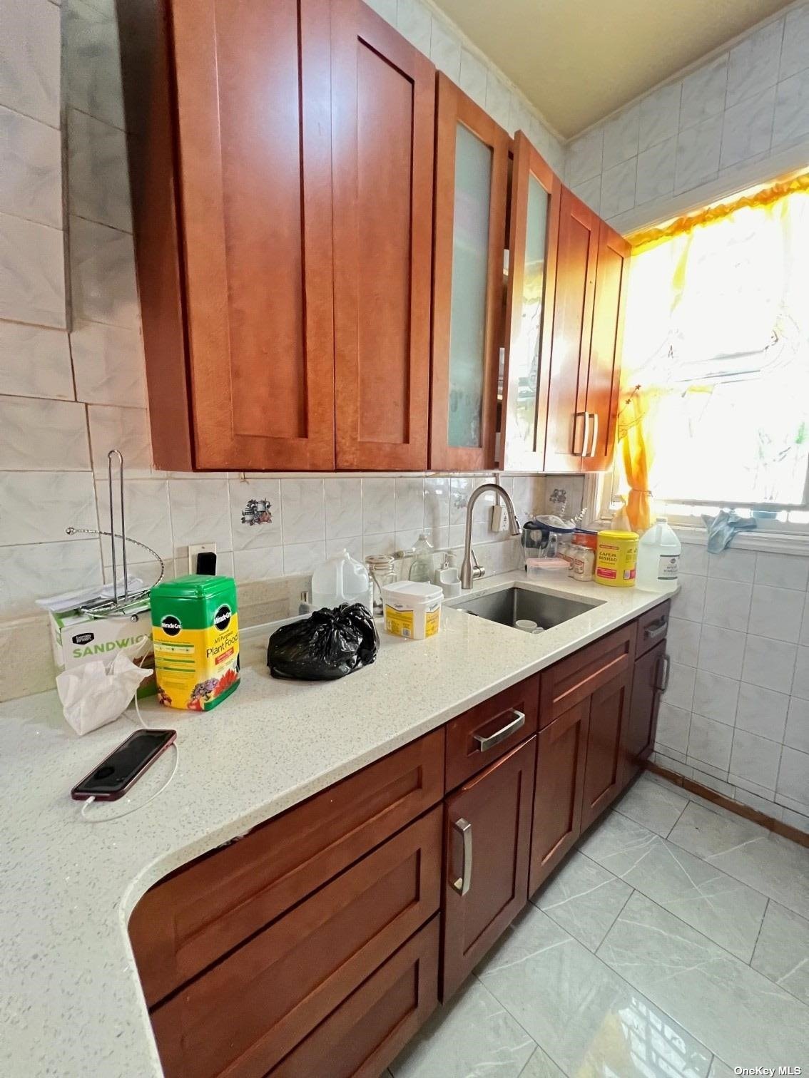 a kitchen with stainless steel appliances a sink window and cabinets