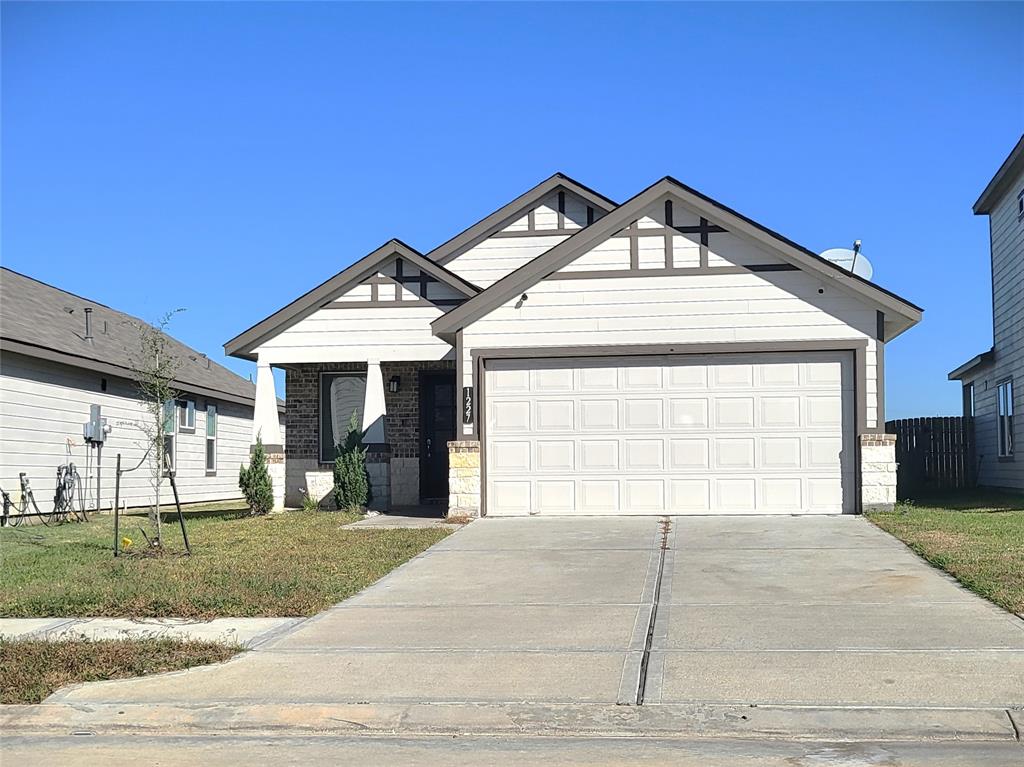 a view of a house with a yard and garage