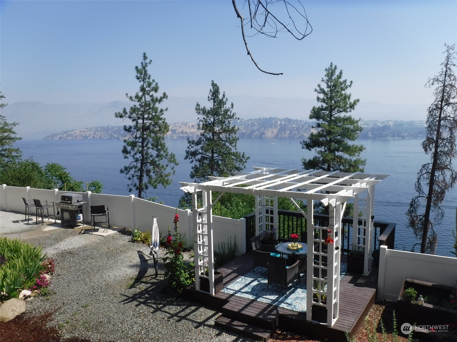 a view of a patio with table and chairs potted plants