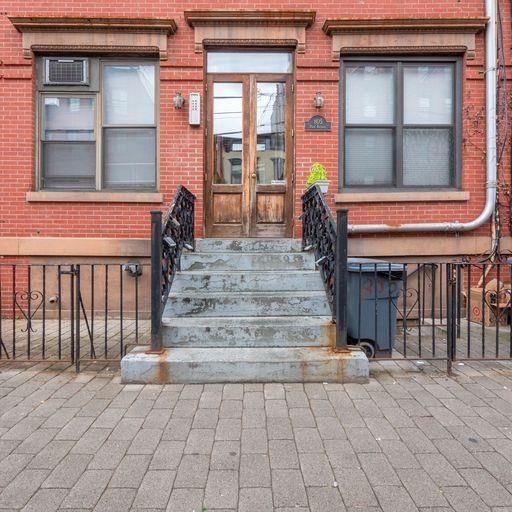 a view of entrance with a house and stairs