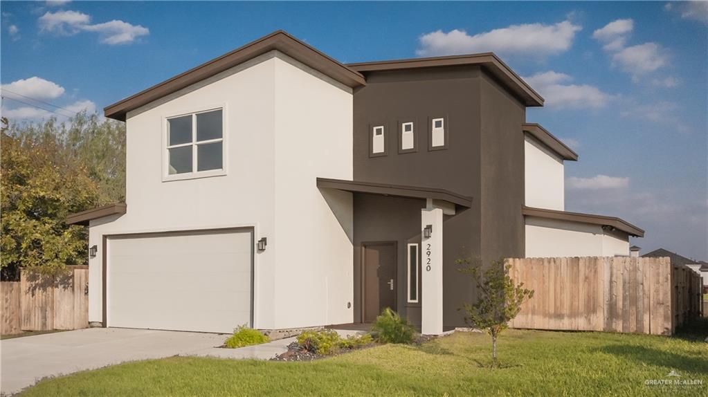 a view of a house with yard and garage