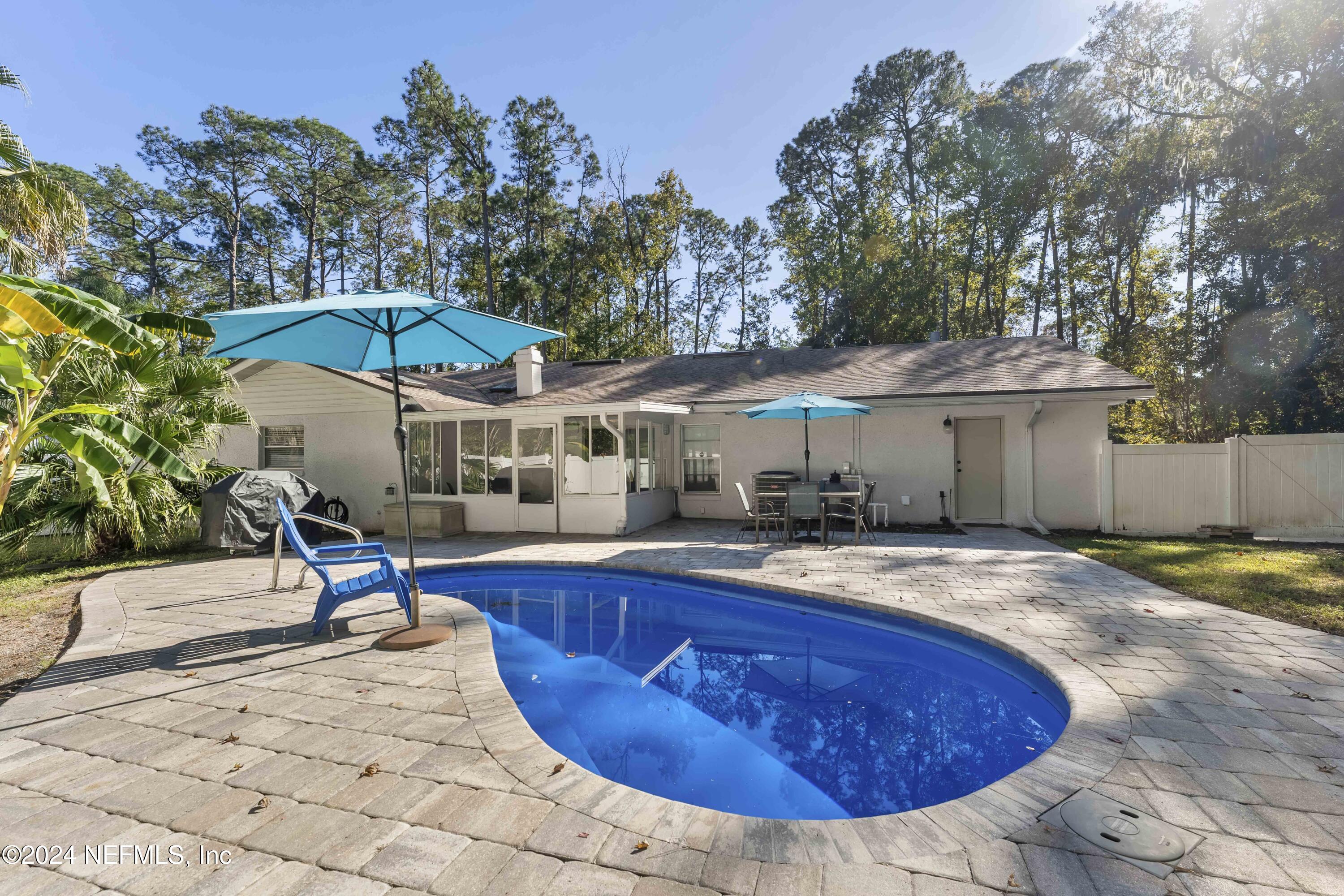 a view of a house with swimming pool and sitting area