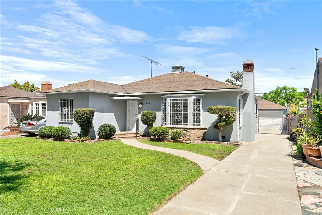 Long driveway leading to a detached 2-car garage