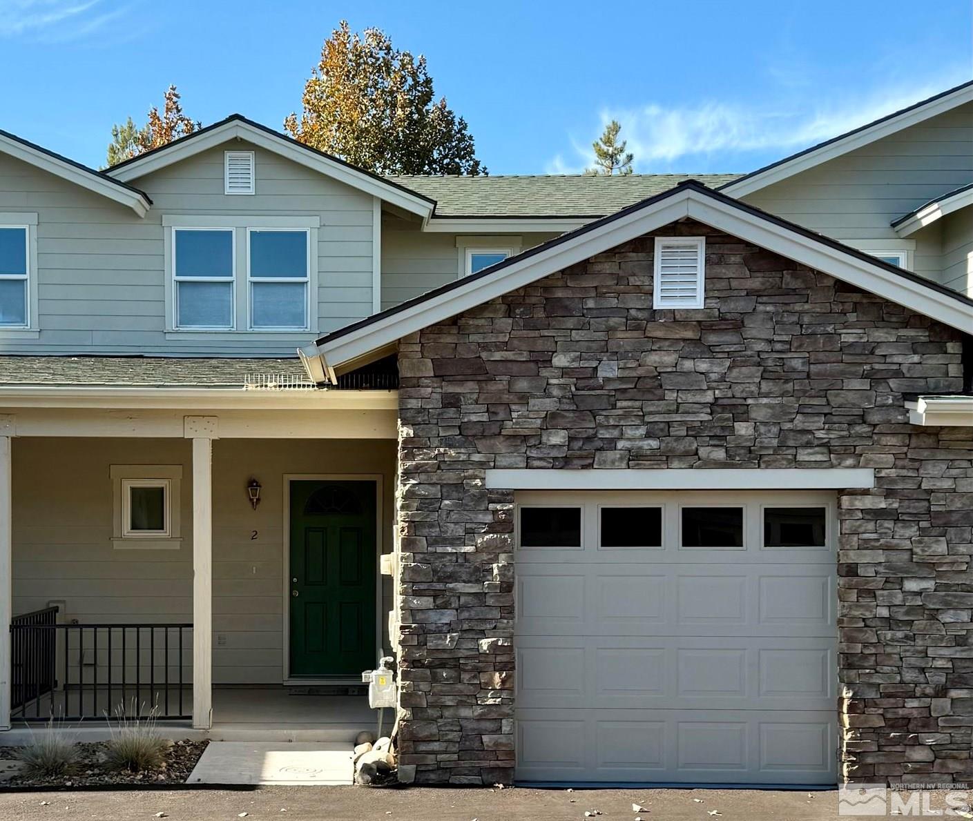 a front view of a house with a garage