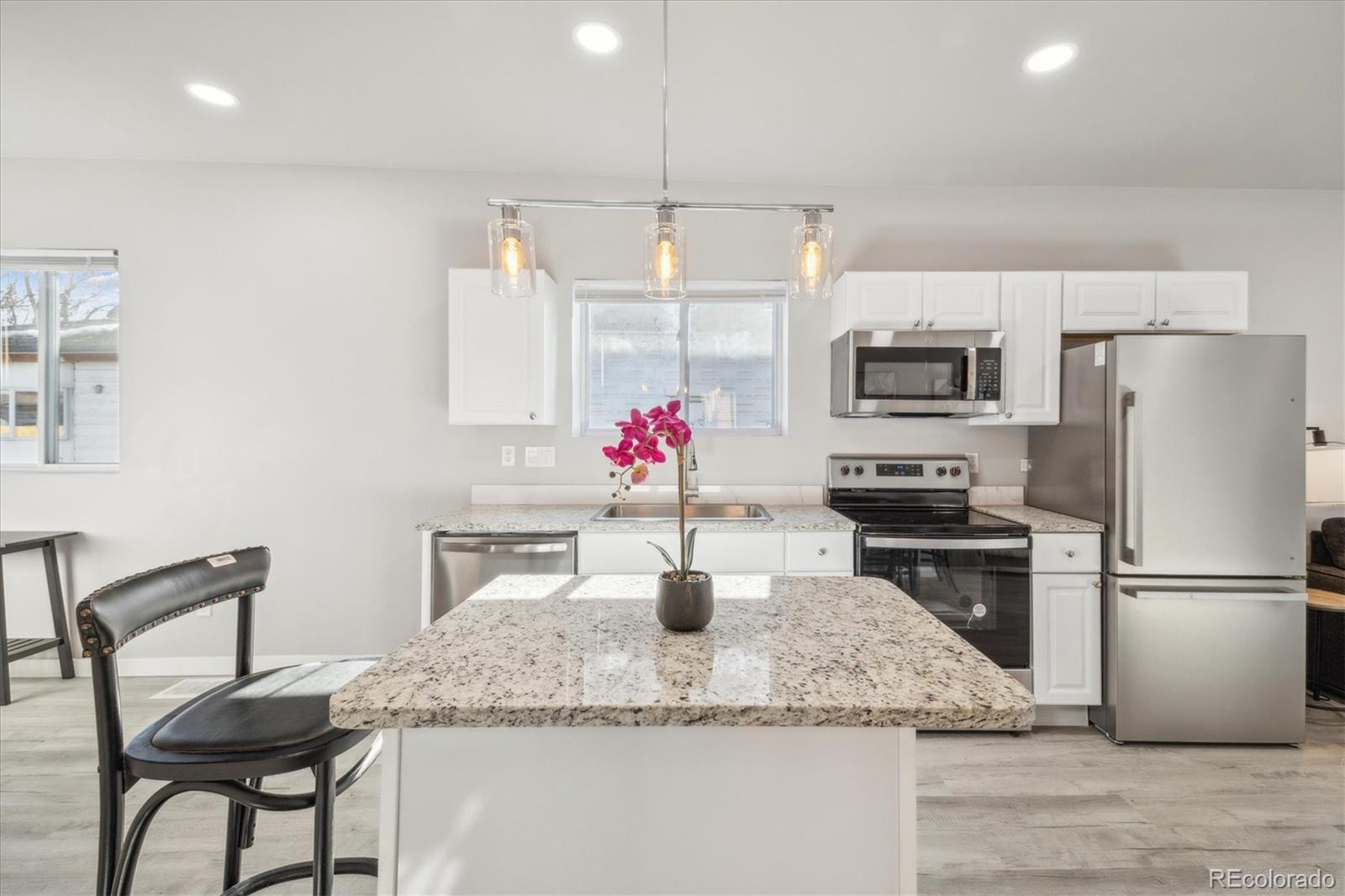 a kitchen with a refrigerator and a sink