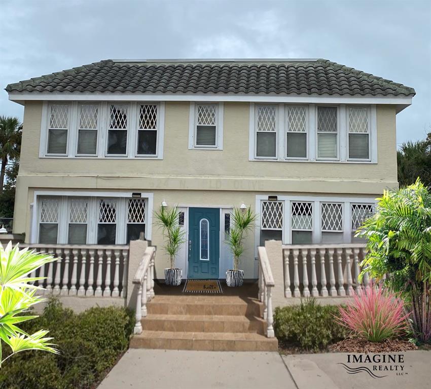 a front view of a house with a garden