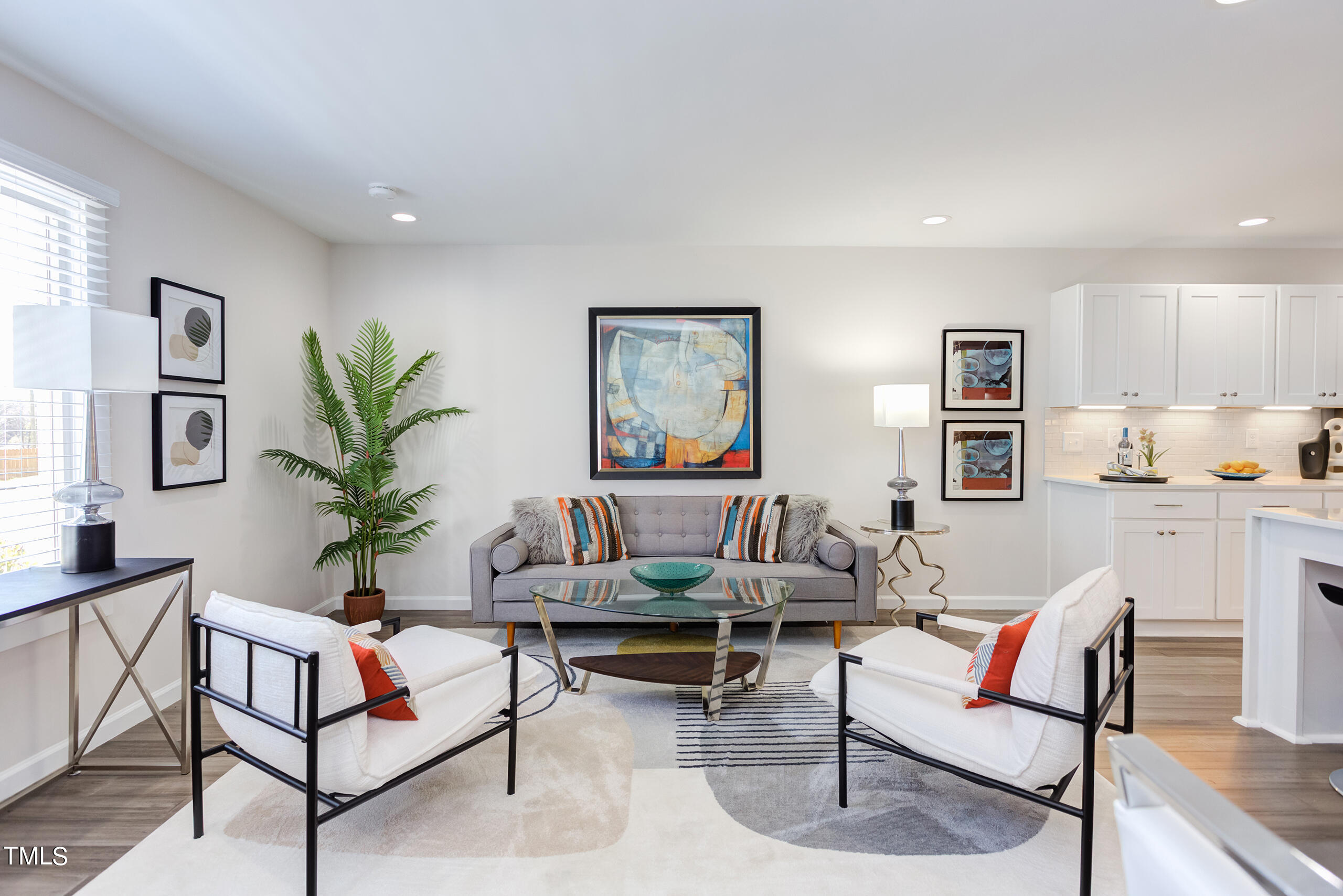 a living room with furniture and a painting