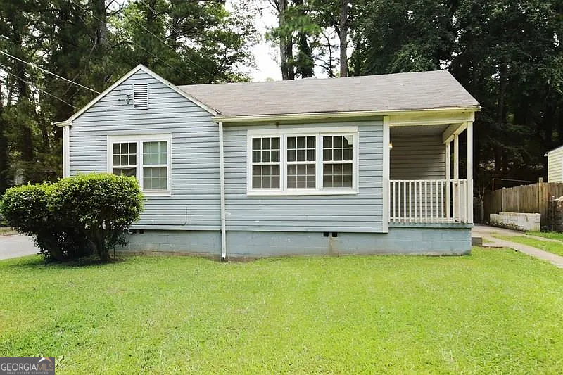 a view of a house with a garden and yard