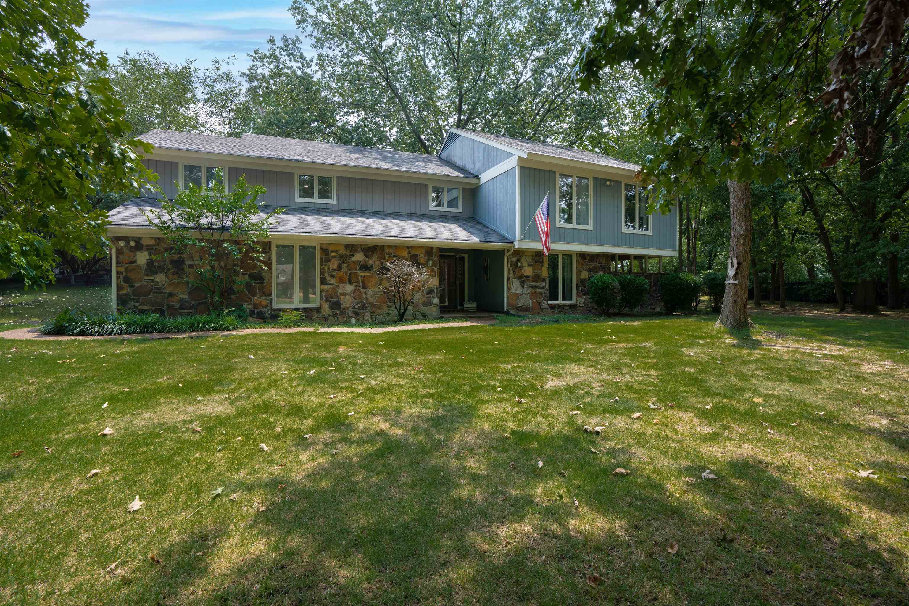 a front view of house with yard and green space