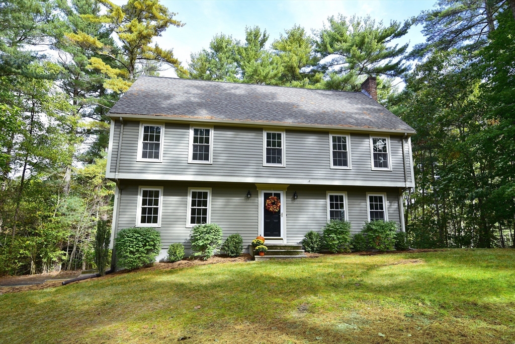 a front view of a house with a yard