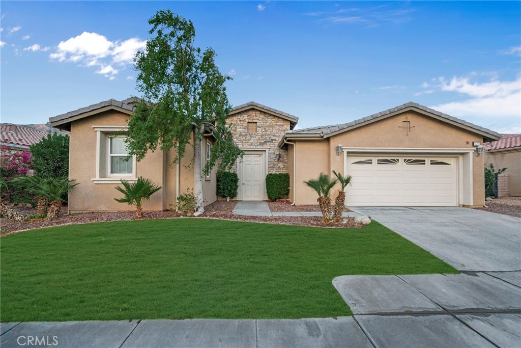 a front view of a house with a yard and garage