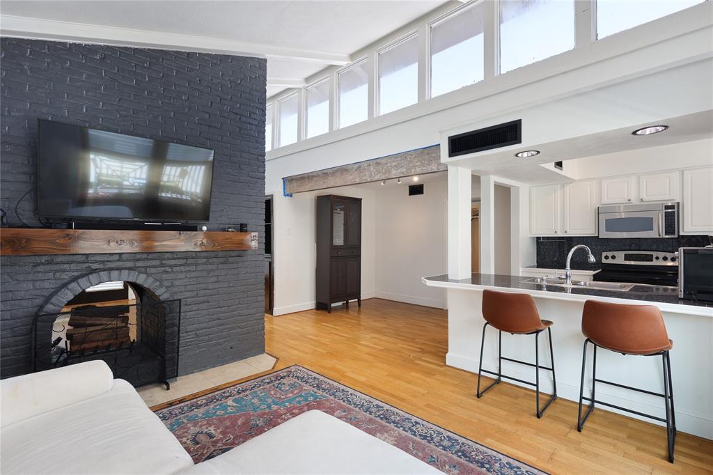 a living room with furniture a flat screen tv and kitchen view