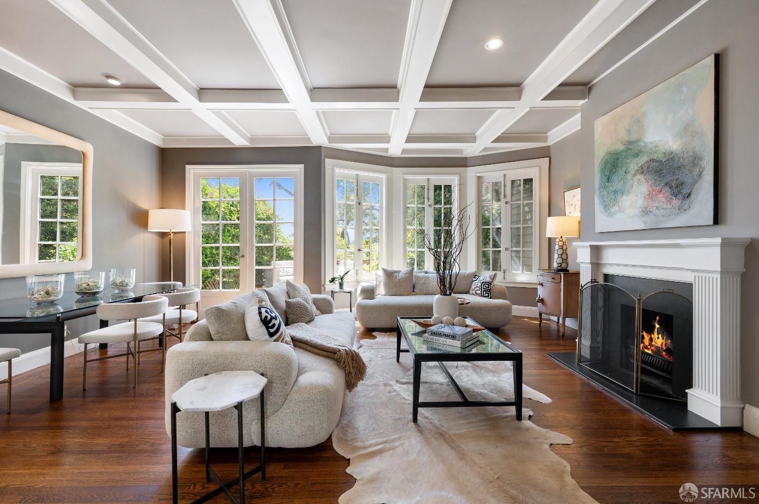 a living room with furniture large window and a fireplace