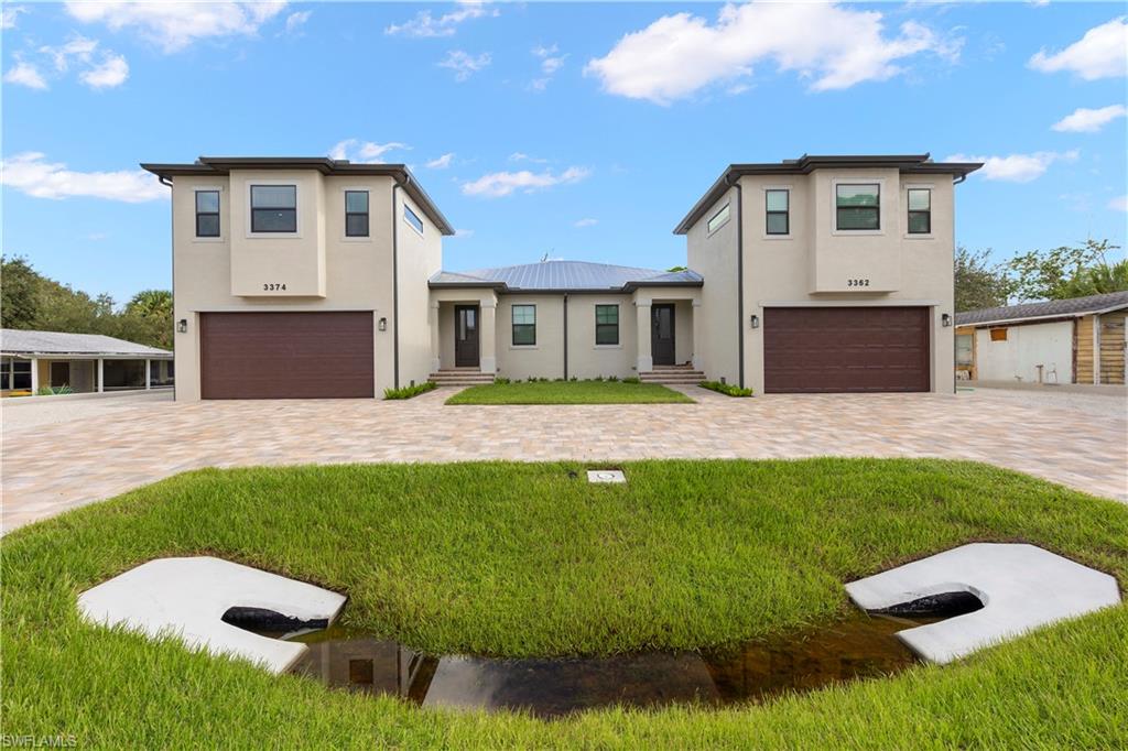 a front view of a house with a yard and garage