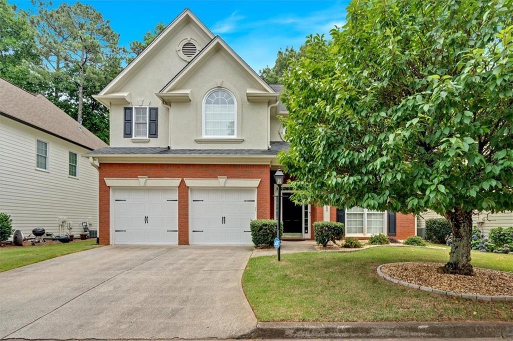 a front view of a house with a yard and garage