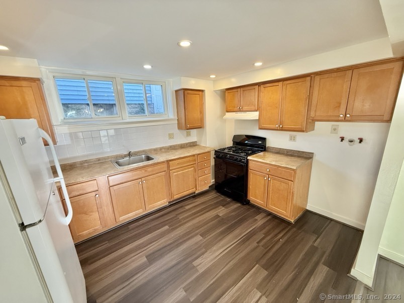 a kitchen with a sink window and cabinets