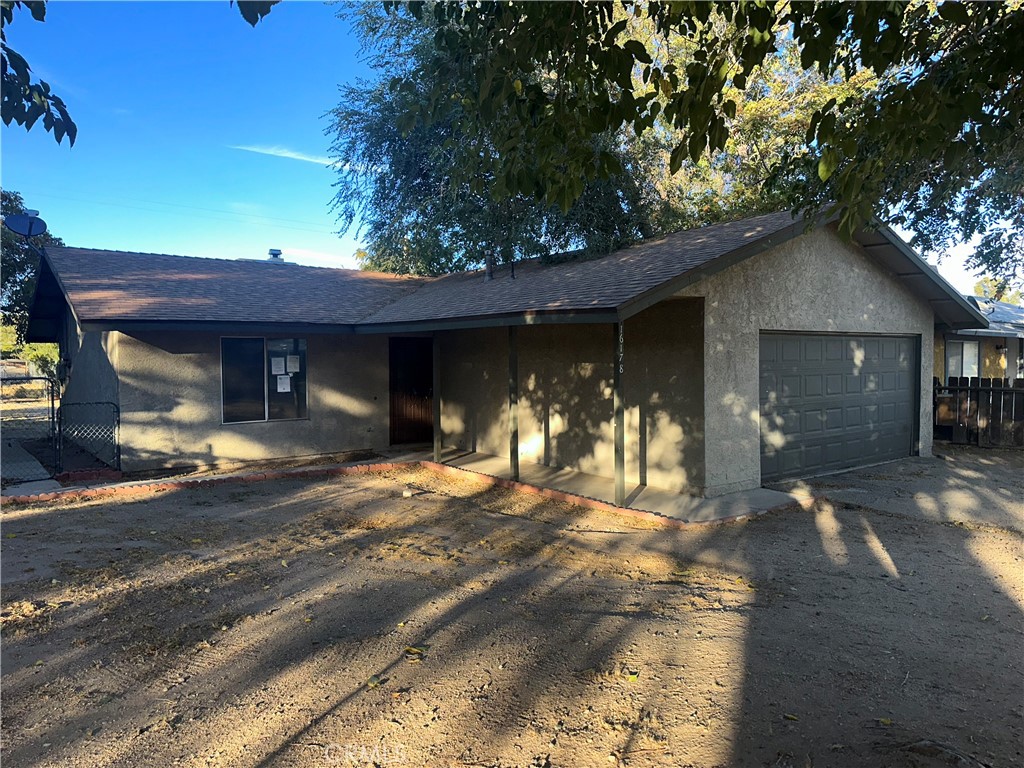 a front view of a house with a yard outdoor seating and garage