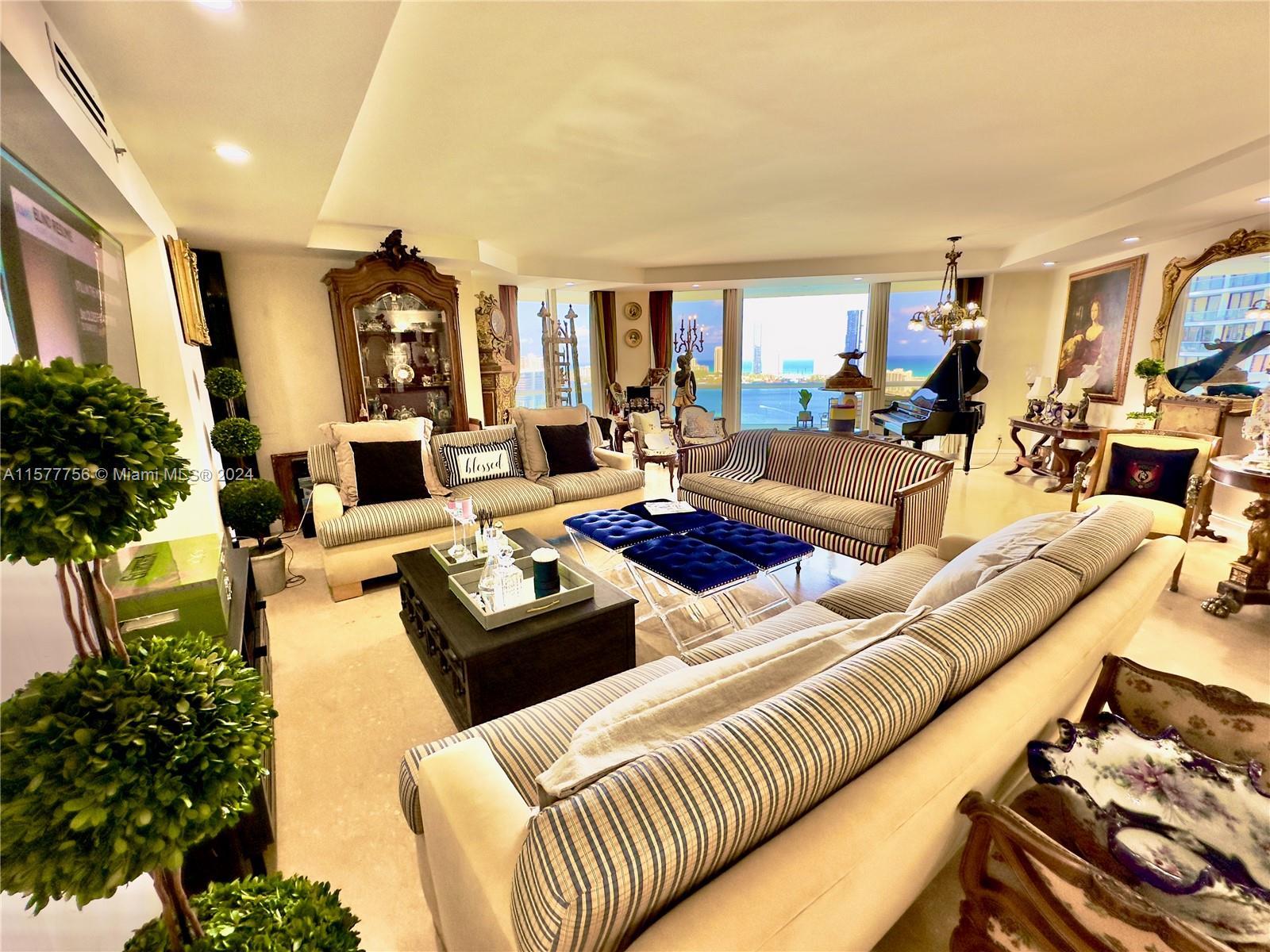 a living room with furniture fireplace and a large window