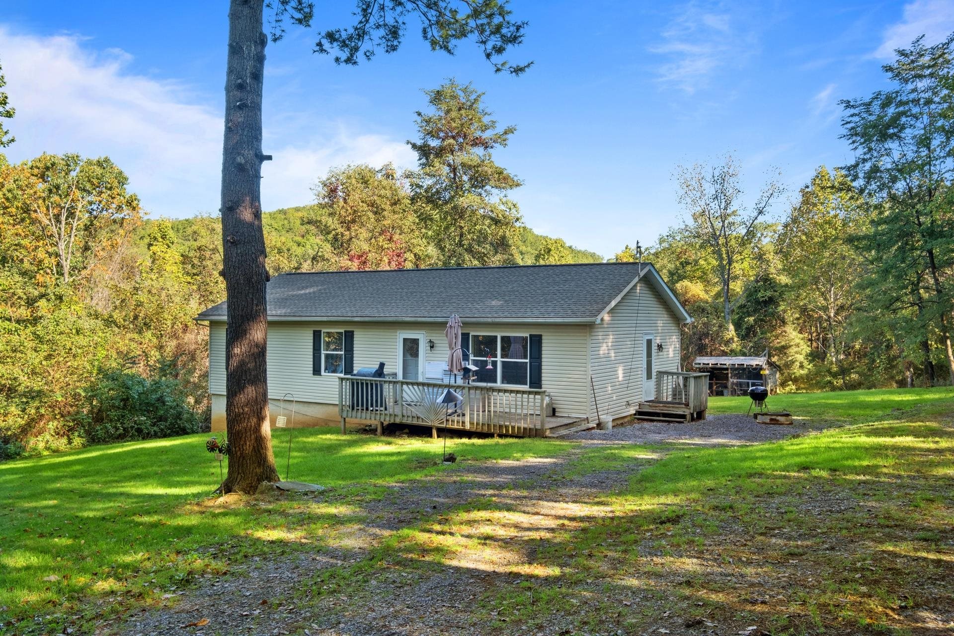 a front view of house with yard and green space