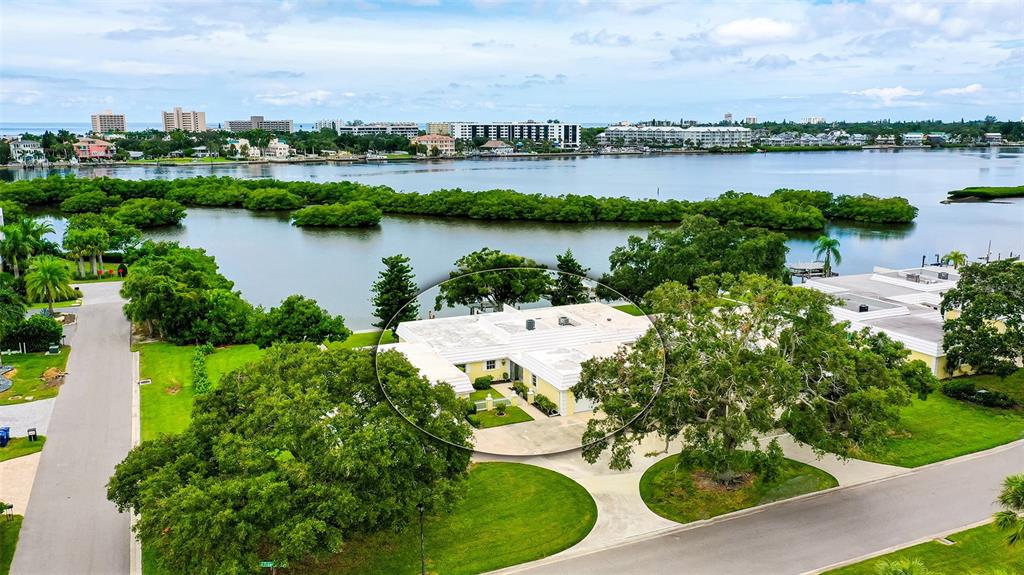 an aerial view of a house with outdoor space and lake view