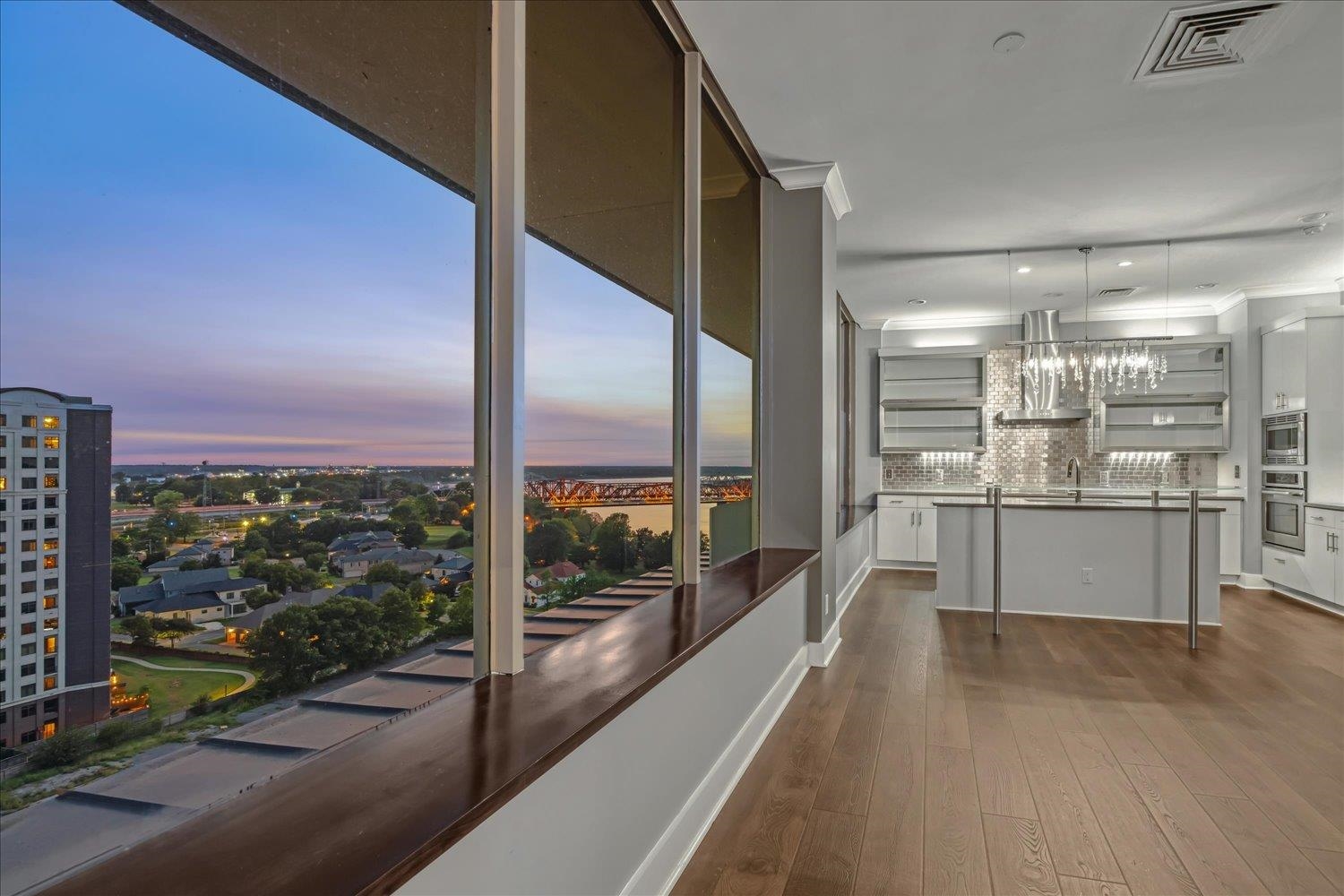 a view of a kitchen with a large window and kitchen view