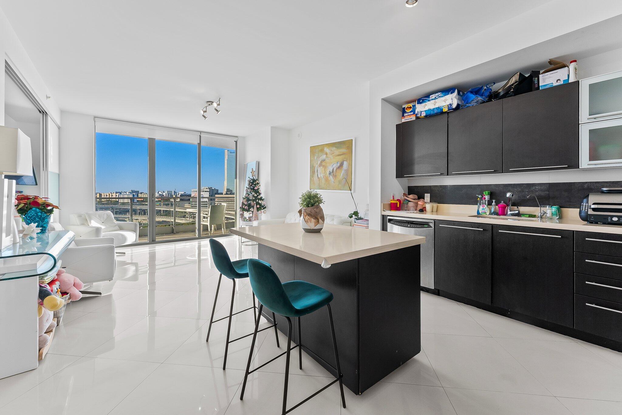 a kitchen with a sink refrigerator and cabinets