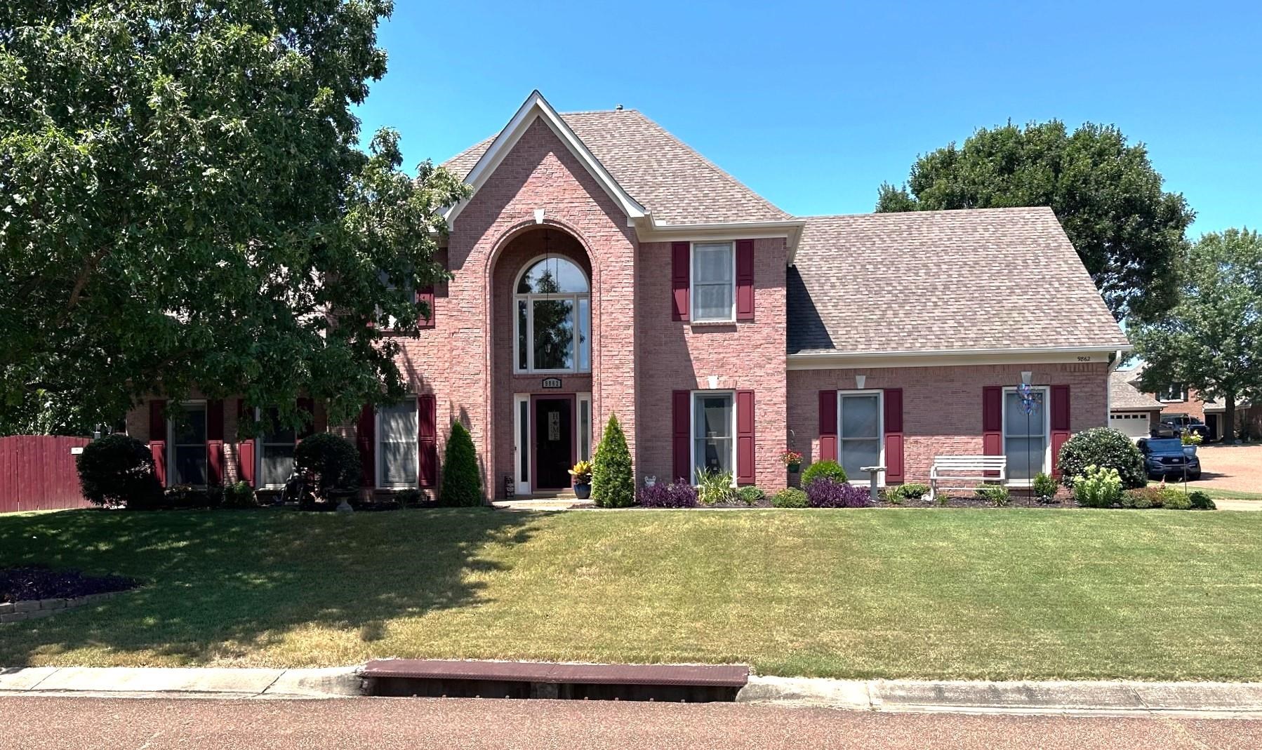 a front view of a house with a yard