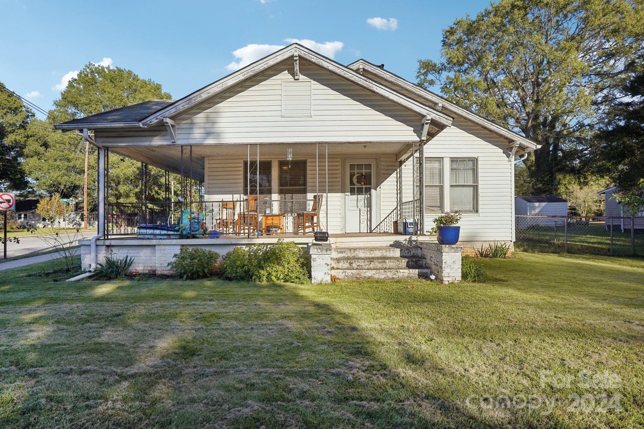 a front view of a house with a yard patio and fire pit