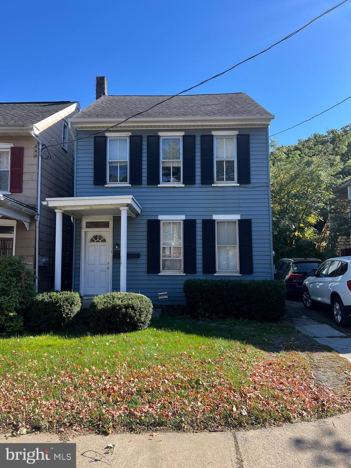 a front view of a house with a garden