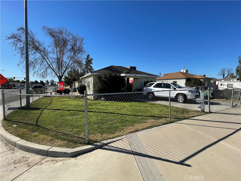 a view of a car park in front of a house