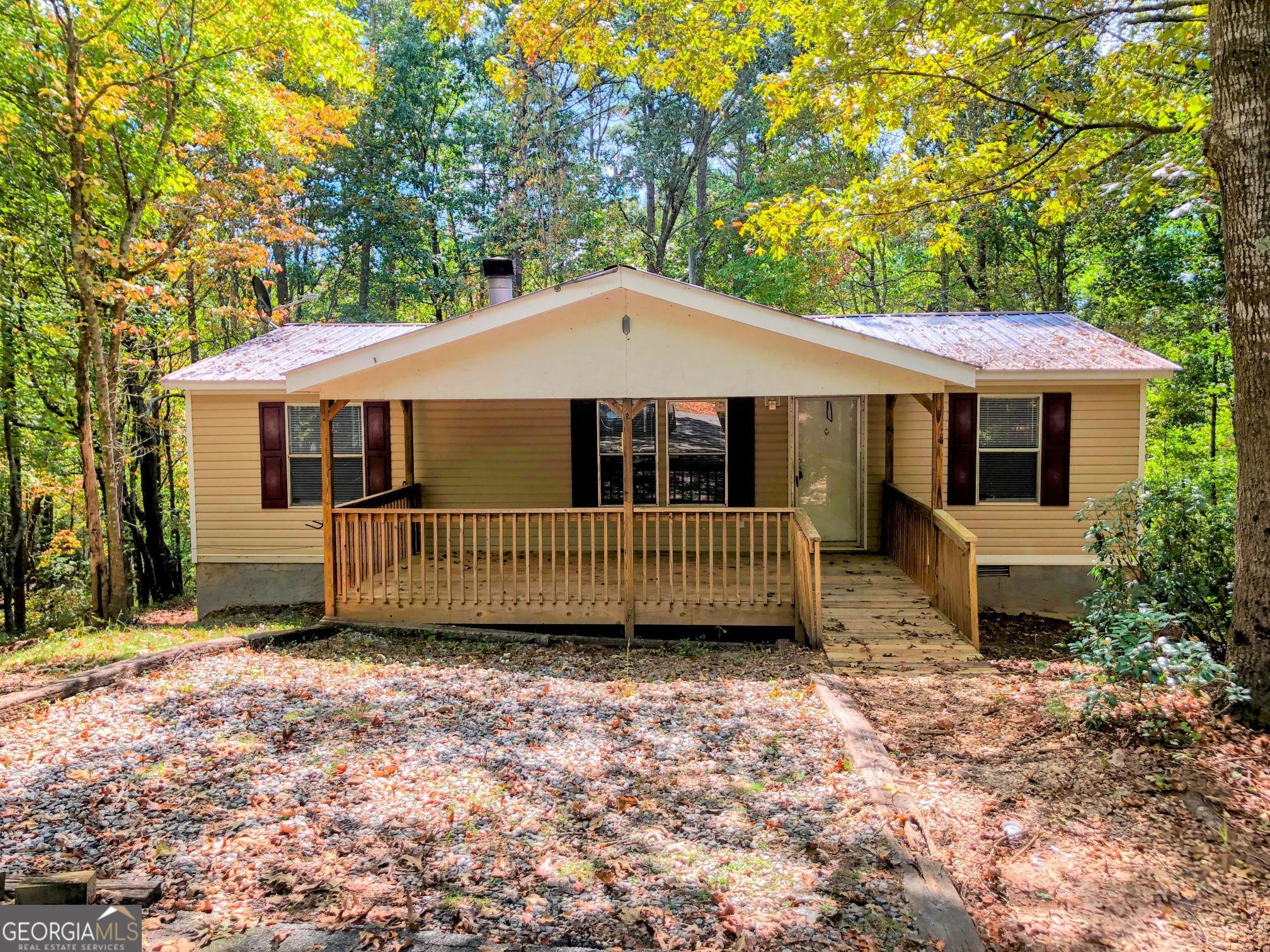 a view of a house with a deck and a yard