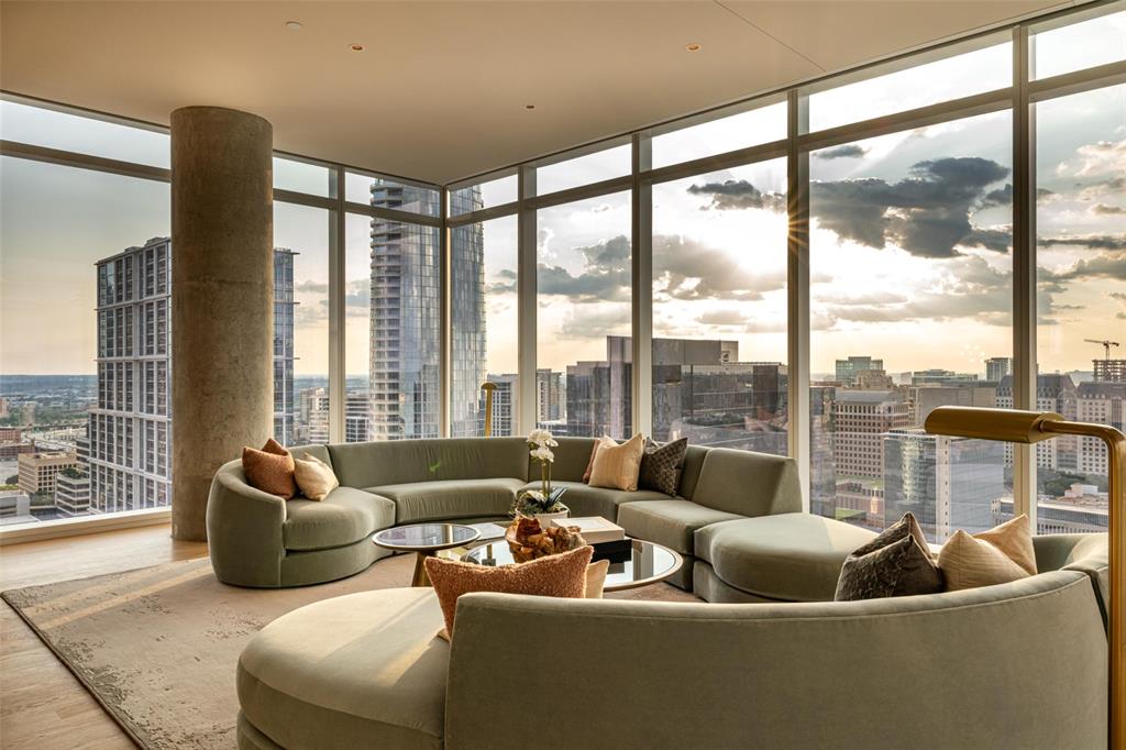 a living room with furniture city view and large windows