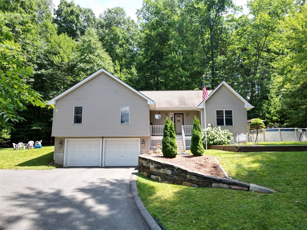 a front view of house with yard and green space