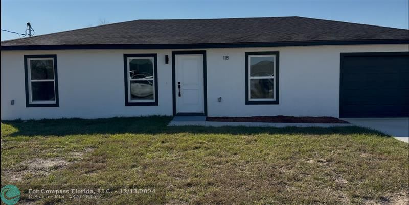 a view of front door and yard