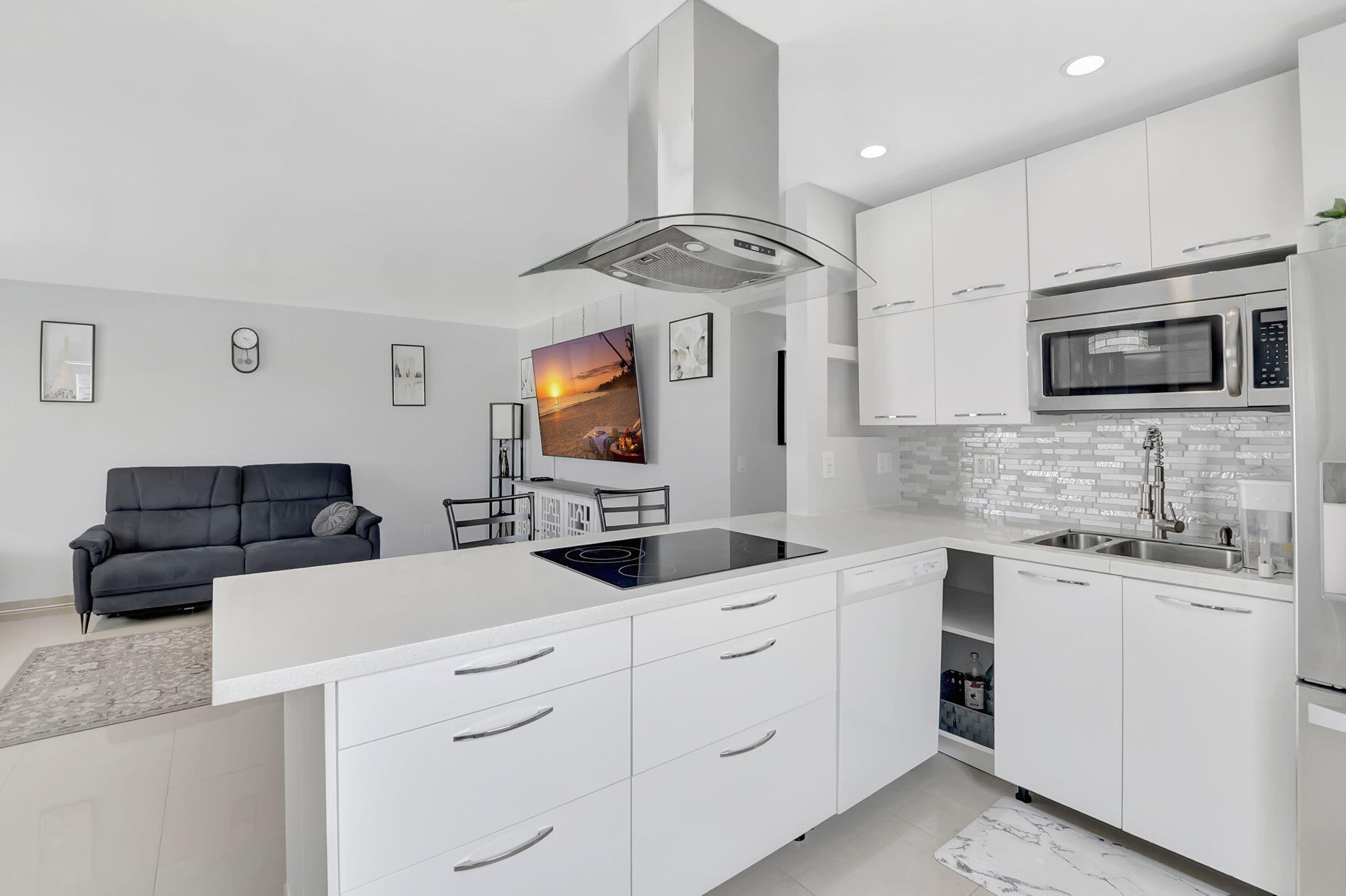 a kitchen with stainless steel appliances a microwave sink and cabinets