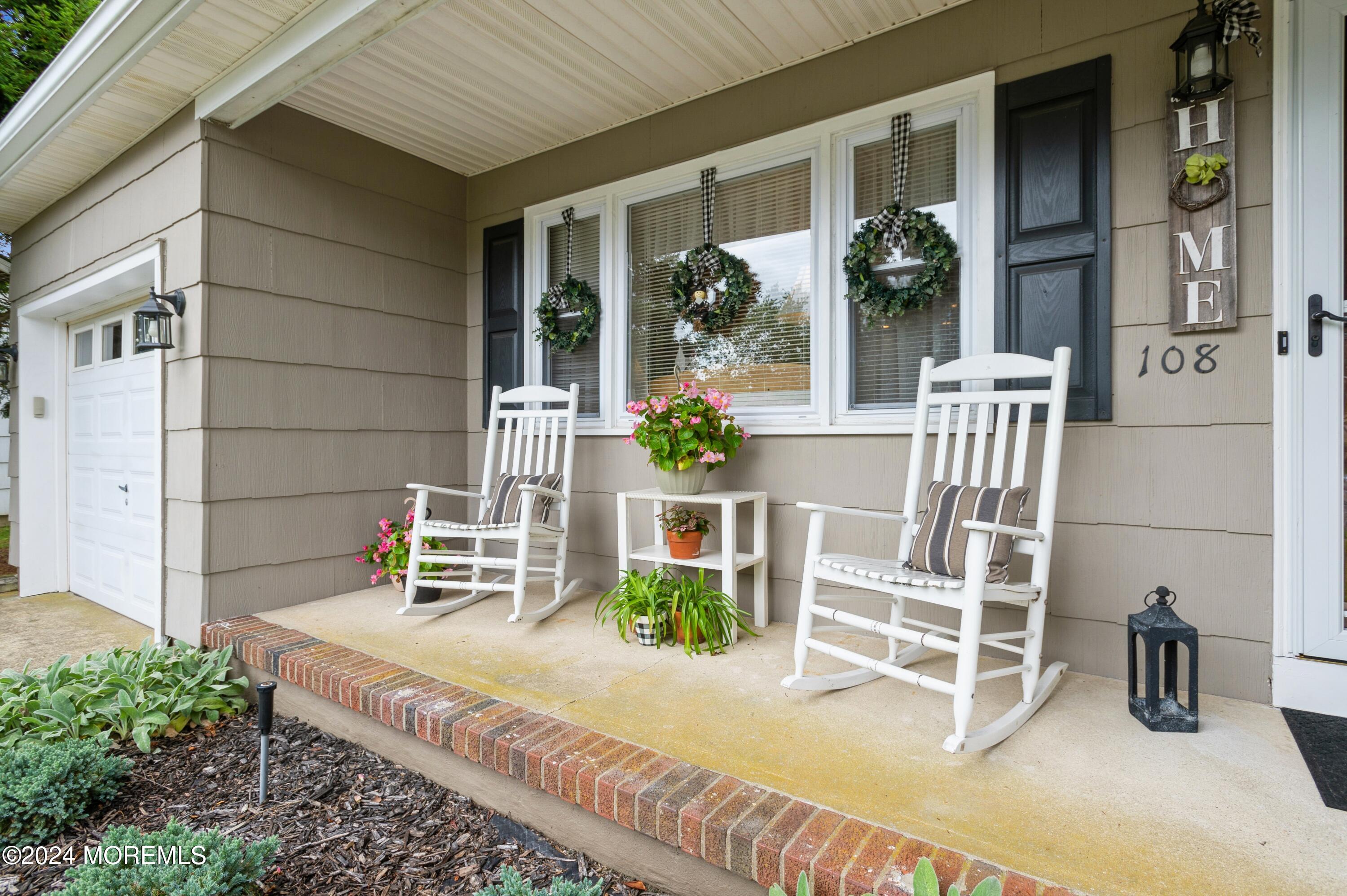 a view of a patio with table and chairs and potted plants