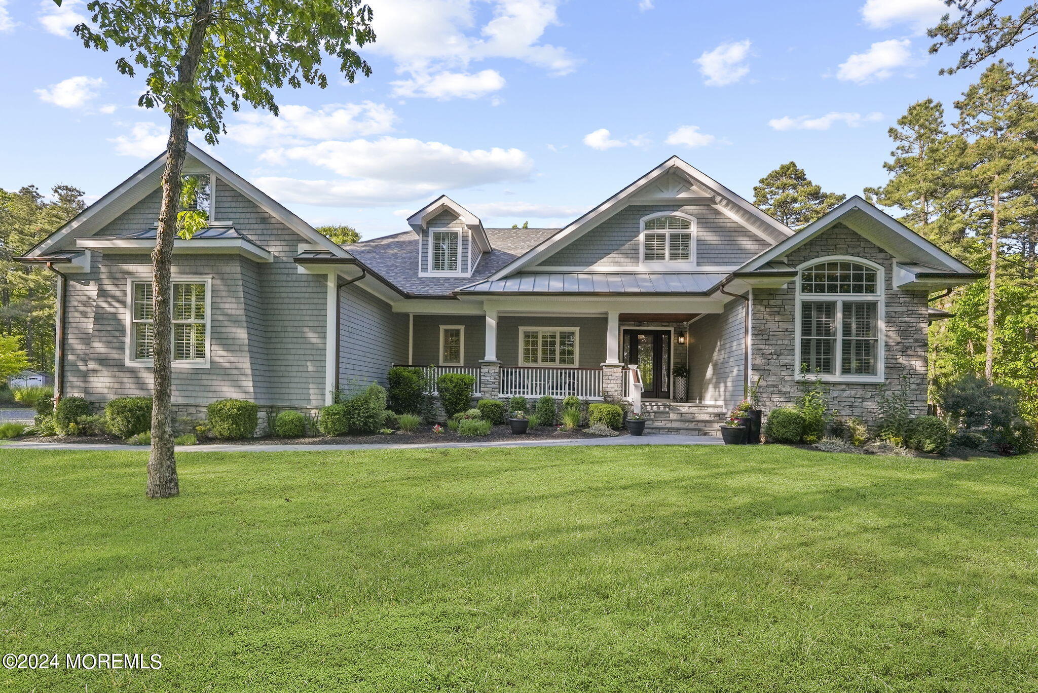 a front view of a house with a garden