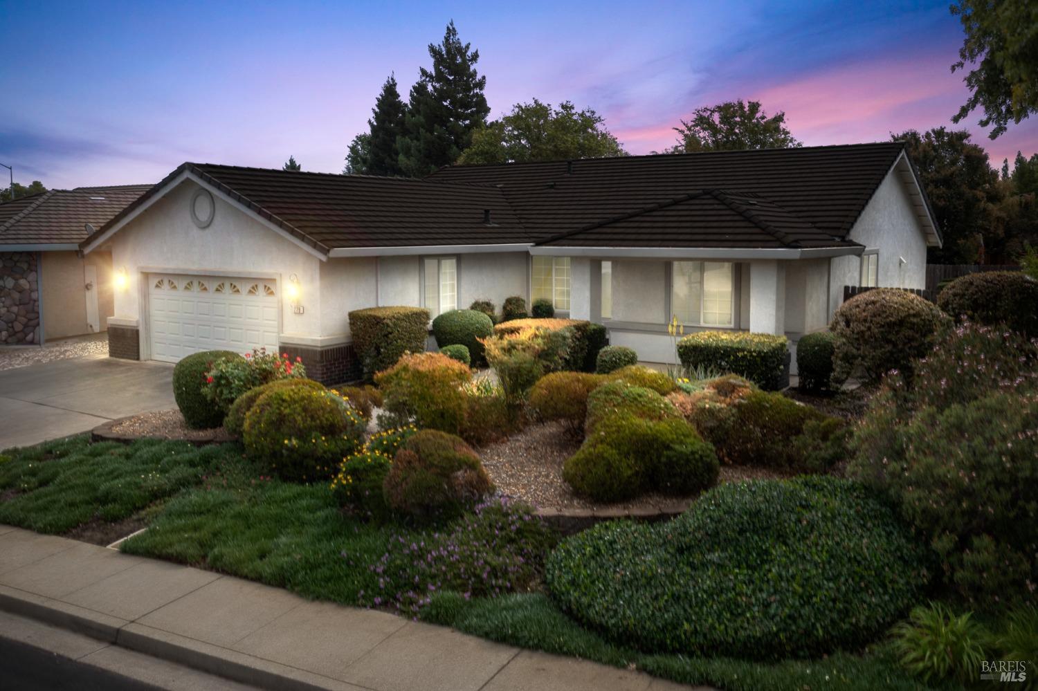 a front view of a house with garden