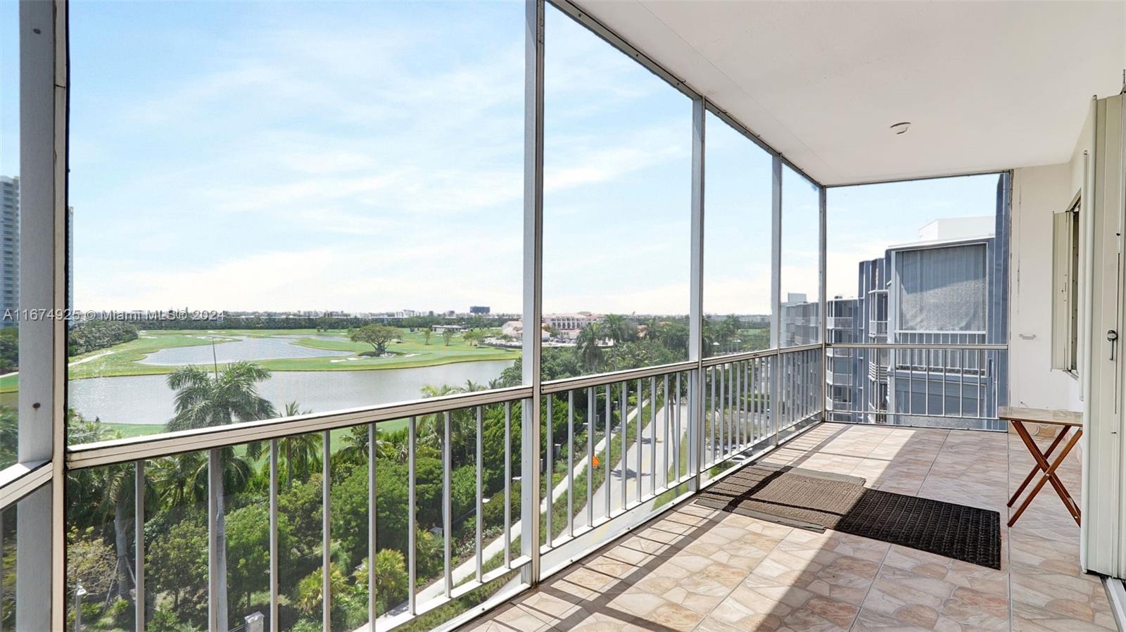 a view of a balcony with floor to ceiling window wooden floor and lake view