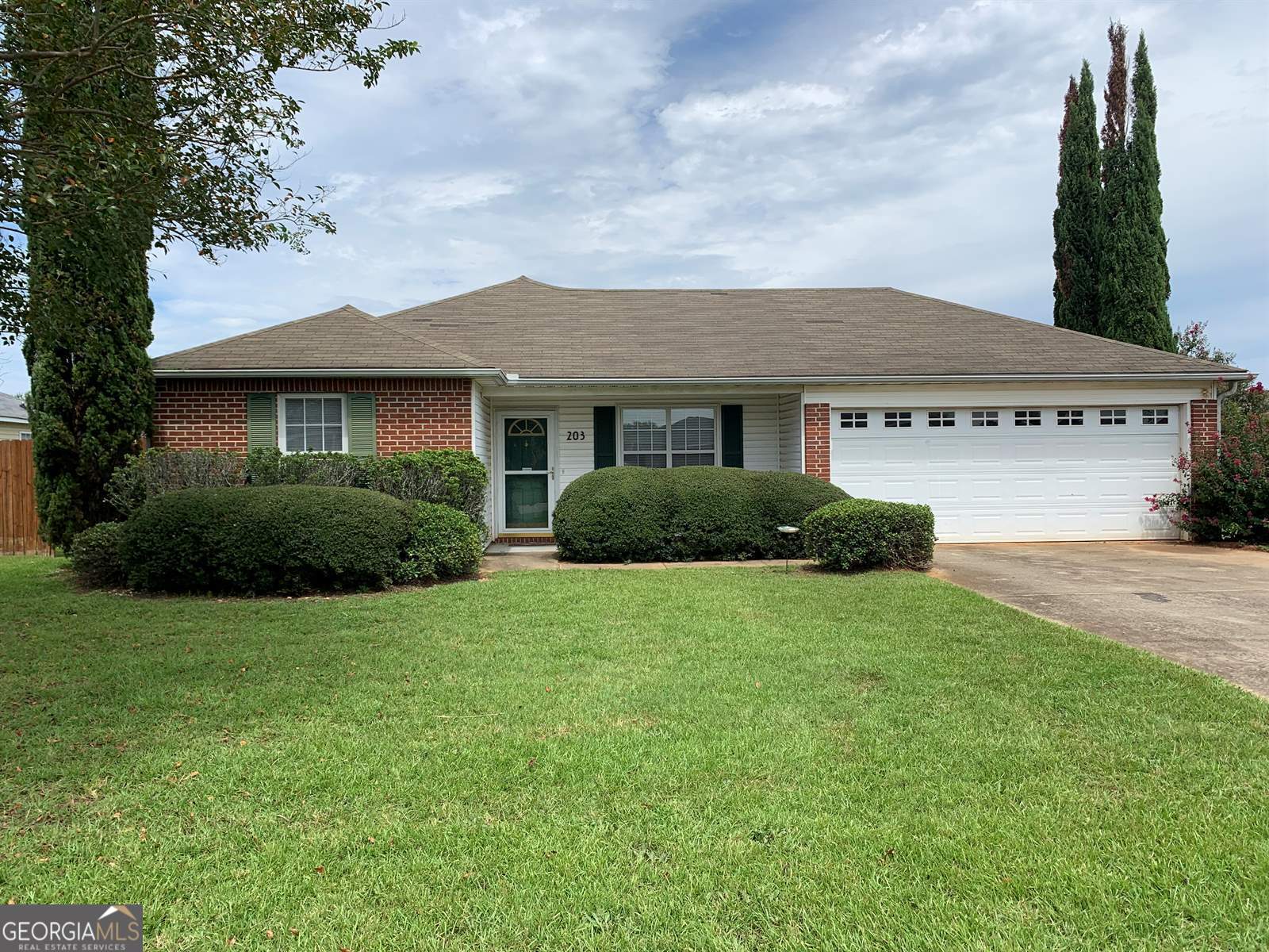 a front view of a house with garden