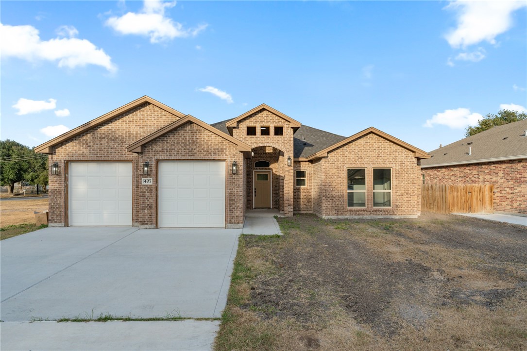 a view of a house with a yard and garage