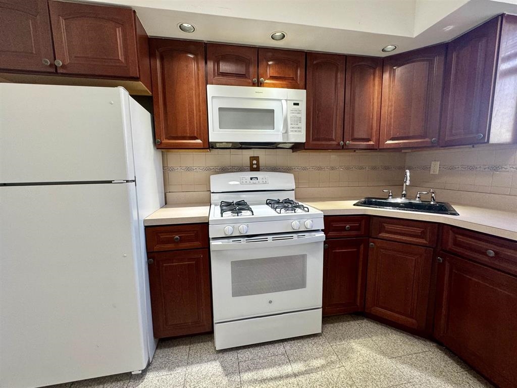 a kitchen with a refrigerator stove and microwave