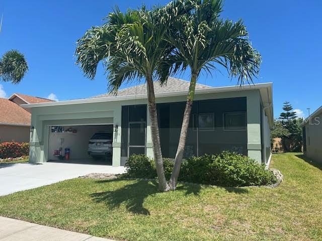 a front view of a house with a garden and palm trees