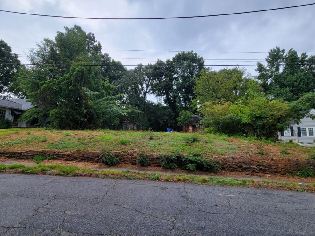 a view of a yard with wooden fence