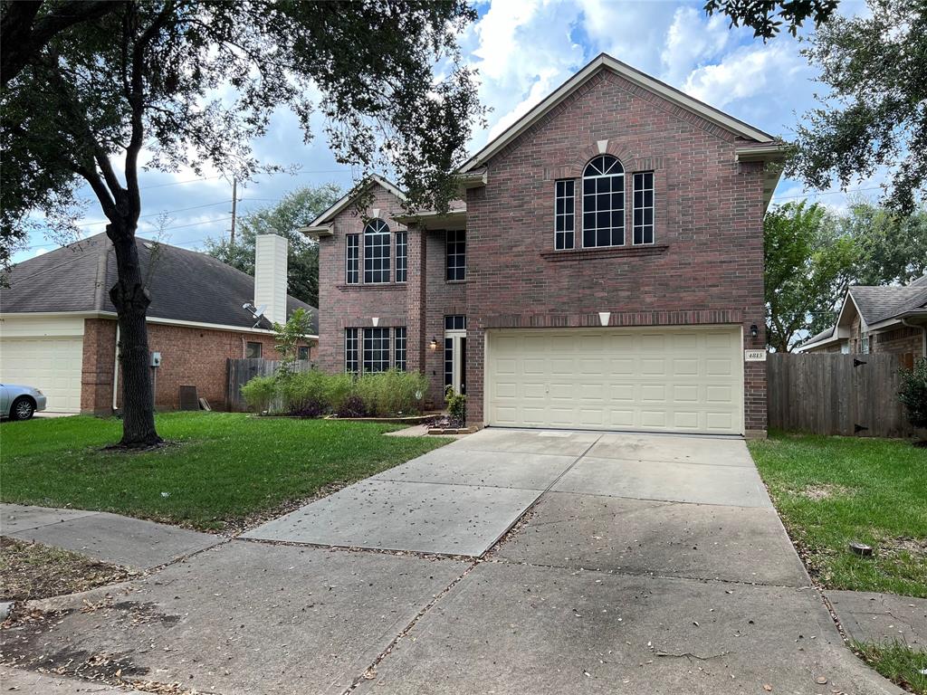 a front view of house with yard and trees