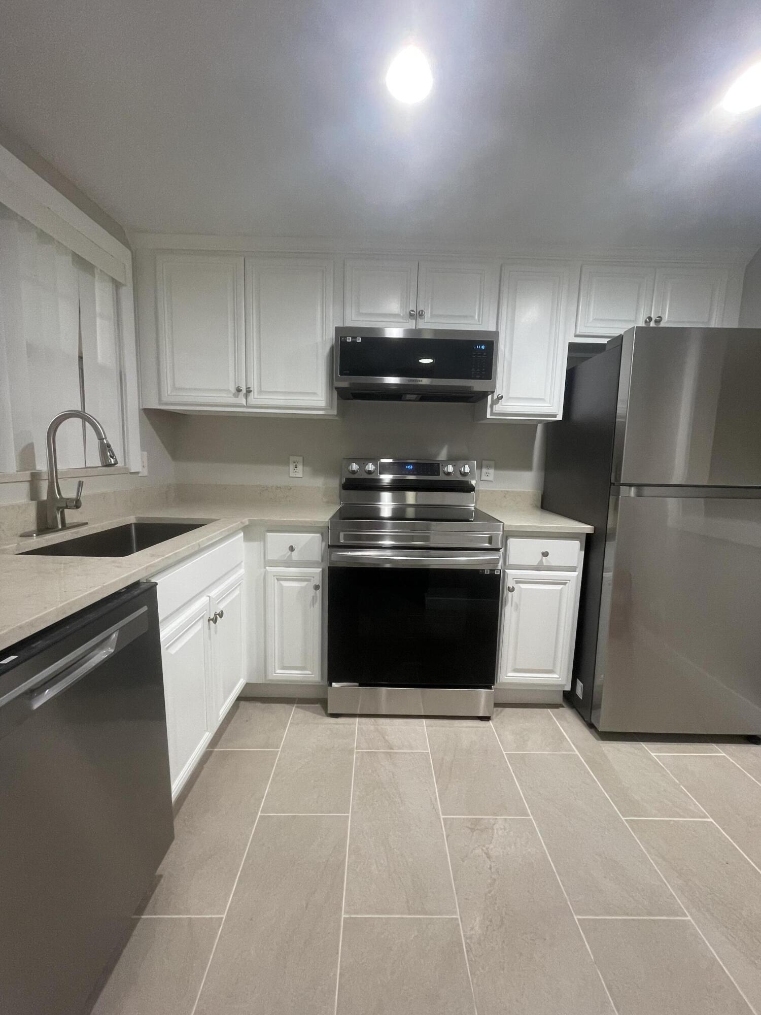 a kitchen with a stove top oven and cabinets