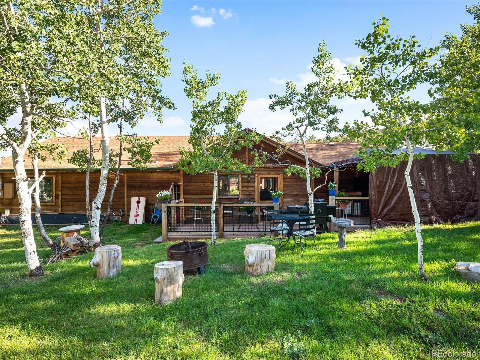 a view of a house with backyard porch and sitting area